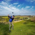 Golfer swinging club on the golf course at Roxburghe Hotel Golf & Spa Ltd.
