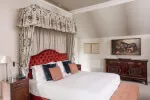 Elegant canopy bed in the Castle Suite at Roxburghe Hotel, surrounded by luxury furnishings for a stylish stay.