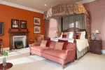 Castle Balcony Suite at 12.18. Roxburghe Hotel: spacious room with open fire, four-poster bed, and balcony.