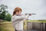 Woman practicing shooting sport at Country Sports Center.