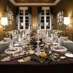 Elegant dinner table setup for a group stay at SCHLOSS Roxburghe Hotel & Spa.