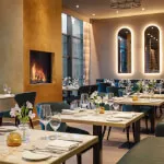 Interior of 12.18. Roxburghe Hotel Golf & Spa's restaurant, embodying Scottish Bistronomy with elegant dining setup.