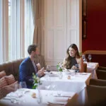 Man and woman enjoying a fine dining experience of local Scottish fare at Sunlaws restaurant, SCHLOSS Roxburghe.