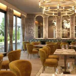 Elegant indoor restaurant at 12.18. Roxburghe Hotel Golf & Spa with tables set for dining.