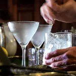 Person preparing a classic cocktail at the Spike Bar, 12.18. Roxburghe Hotel Golf & Spa Ltd