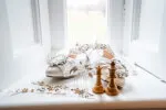 White shoes and chess pieces on a window sill, hinting at a relaxing time at Roxburghe Hotel.