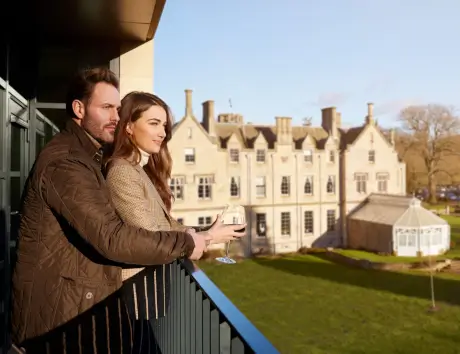 A couple enjoying drinks with the Roxburghe Hotel in the background.
