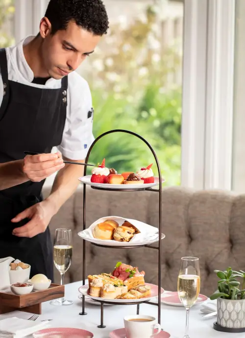 Chef preparing festive afternoon tea with treats and champagne at 12.18. Roxburghe Hotel Golf & Spa.