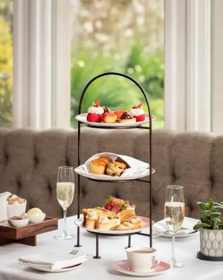 Elegant three-tier afternoon tea with pastries and champagne at Roxburghe Hotel Golf & Spa.