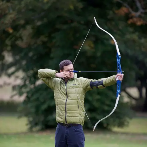 A man practicing archery outdoors at Roxburghe Hotel Golf & Spa.