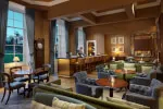 Elegant bar area at Roxburghe Hotel Golf & Spa featuring comfortable seating and a bartender.