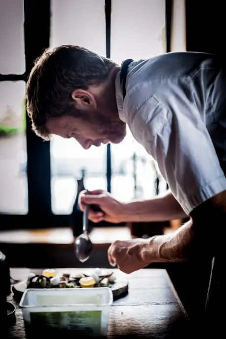 Chef plating a dish at Roxburghe Hotel Golf & Spa.