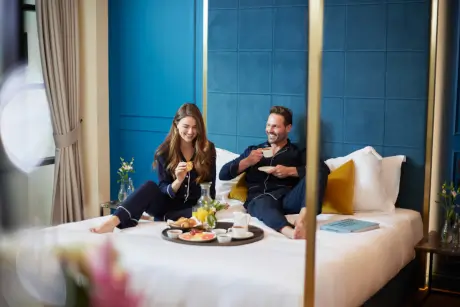 Couple enjoying festive afternoon tea at Roxburghe Hotel in a stylish room.