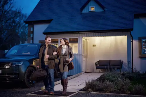 Couple arriving at Roxburghe Hotel Golf & Spa, excited after a day of adventures.