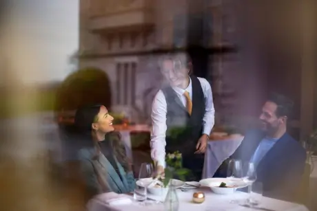 Couple enjoying dinner service at Roxburghe Hotel Golf & Spa's Christmas escape package.