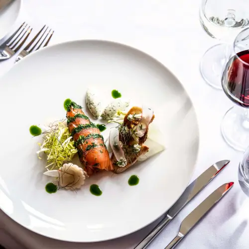 Gourmet smoked salmon dish with wine at Roxburghe Hotel Golf & Spa.