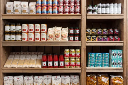 Shelves stocked with pasta, sauces, and snacks at 12.18. Roxburghe Hotel Golf & Spa Ltd.