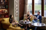 Friends enjoying drinks at Roxburghe Hotel Golf & Spa's lounge.