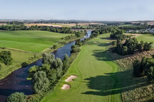 Aerial view of Roxburghe Hotel Golf Course with river and lush greenery.