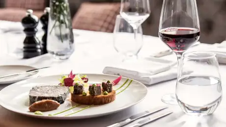 Gourmet meal and red wine at Roxburghe Hotel Golf & Spa, perfect for a luxurious dining experience.