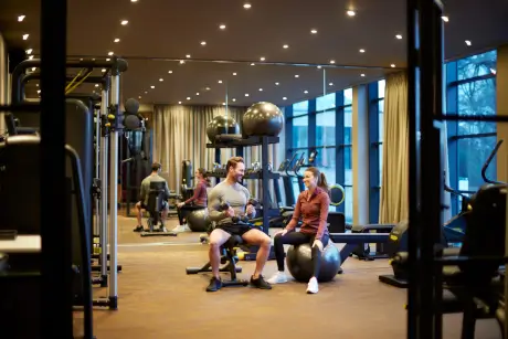 Two people enjoying a workout at Roxburghe Hotel Golf & Spa gym.