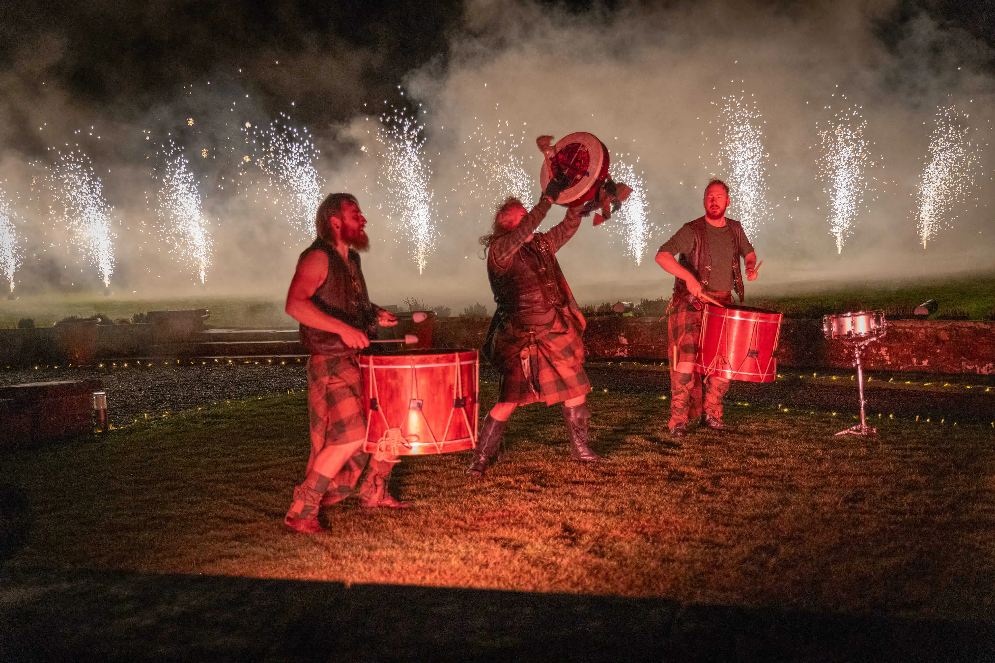 Celebration drummers in kilts performing with fireworks at Roxburghe Hotel.