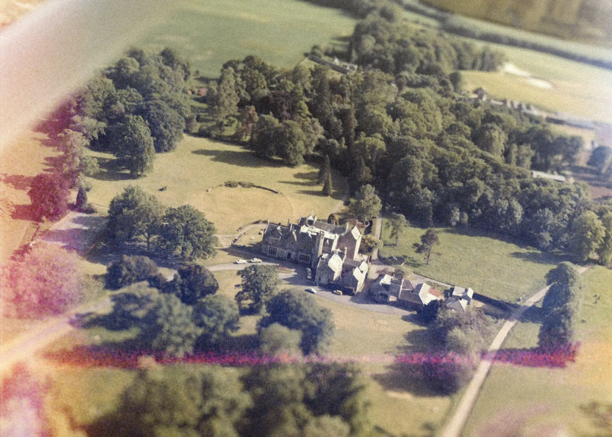 Aerial view of Roxburghe Hotel, surrounded by lush greenery and a serene landscape.