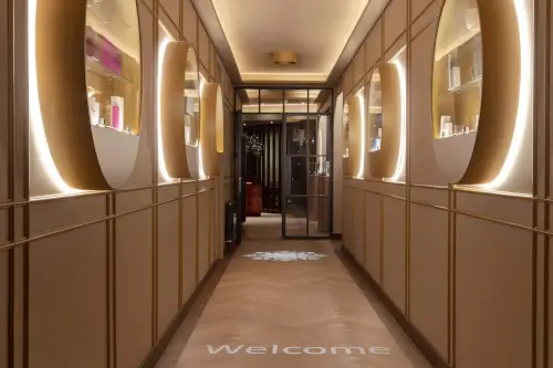 Elegant hotel corridor with a warm welcome sign and stylish lighting.