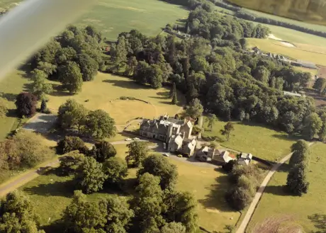 Aerial view of Roxburghe Hotel Golf & Spa with lush greenery and a golf course.