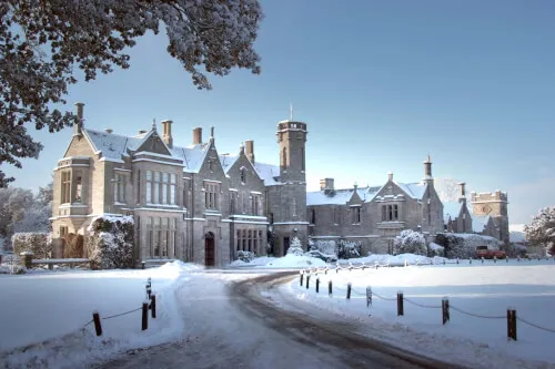 Roxburghe Hotel Golf & Spa in winter, a stunning stately building covered in snow.