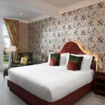 Luxurious hotel room at Roxburghe with a king-size bed and elegant furnishings.