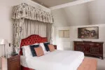 Elegant hotel room at Roxburghe Hotel Golf & Spa with luxurious bed and tasteful decor.