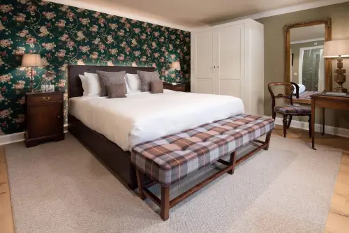 Luxurious hotel room at Roxburghe Hotel Golf & Spa with a double bed and classic decor.