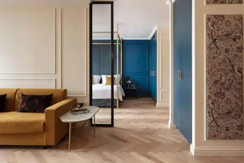 Stylish hotel room featuring a modern yellow sofa and bed in Roxburghe Hotel.