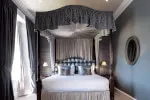 Luxurious bedroom at Roxburghe Hotel Golf & Spa Ltd featuring a grand bed and elegant decor.