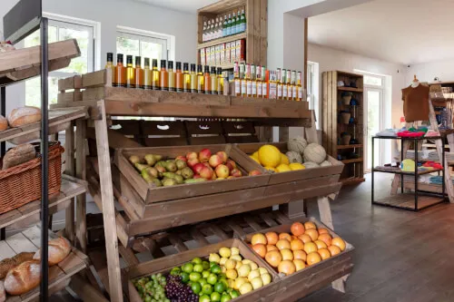 Fresh produce and beverages displayed in a charming store.