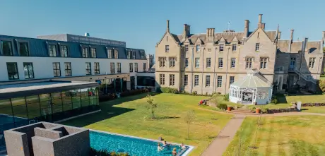 Roxburghe Hotel Golf & Spa's stunning architecture and pool area under clear blue skies.