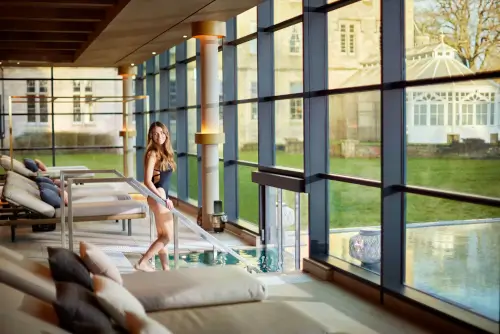 A guest enjoying the tranquil spa at Roxburghe Hotel Golf & Spa, overlooking a beautiful garden.