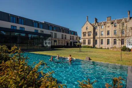 Guests swimming in the outdoor pool at Roxburghe Hotel Golf & Spa Ltd.