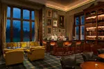 Cozy Library Bar at Roxburghe Hotel with stylish seating and a well-stocked bar.